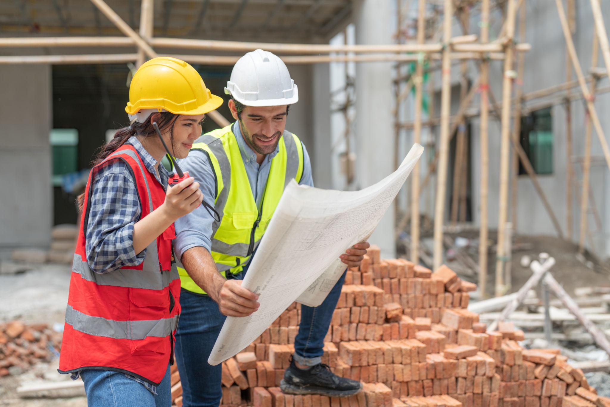 Construction engineers working on building site